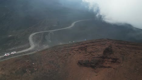 Group-Tourist-People-Hike-on-Crater-of-Mount-Etna-Vulcano-in-Sicily,-Italy---Aerial-4k