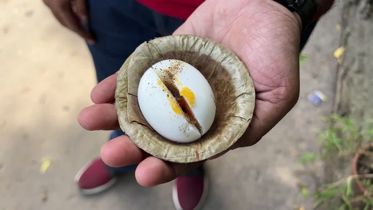 Sliced soft boiled egg on outdoor background.