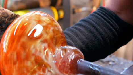 glassblowers shaping a molten glass