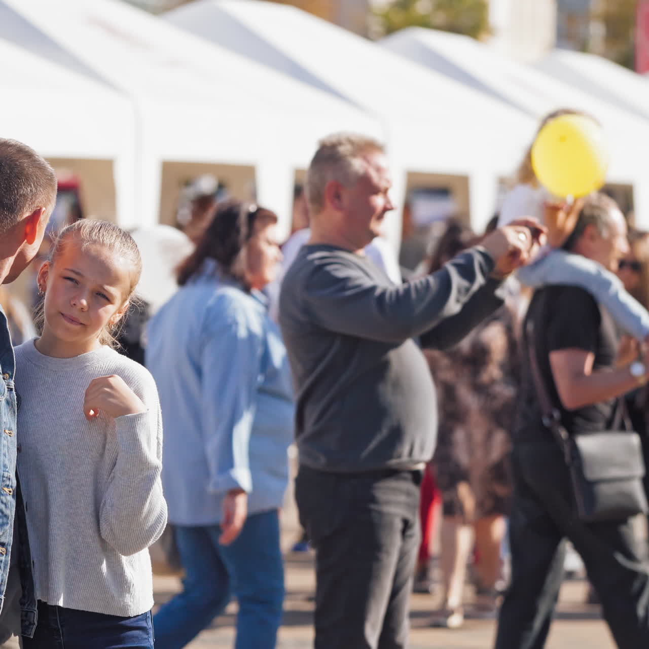 Family walking on the blur city background. People in the busy city street. Crowds of people having rest in the center of the city.