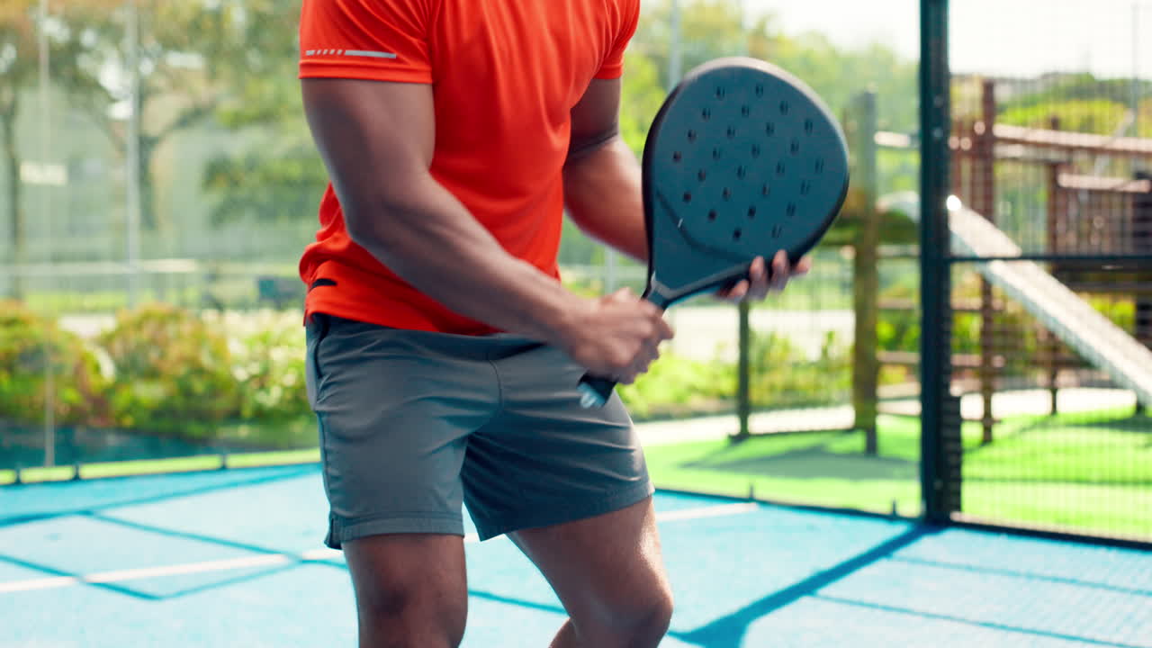 Man Playing Padel Tennis on an Outdoor Court