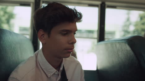 indian teen boy sitting bus talking passenger close up. teenager communicating.