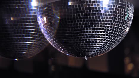 shiny disco mirror ball turning in seamless loop. rotating mirror disco ball shimmering in the hall. mirror ball spins clockwise.