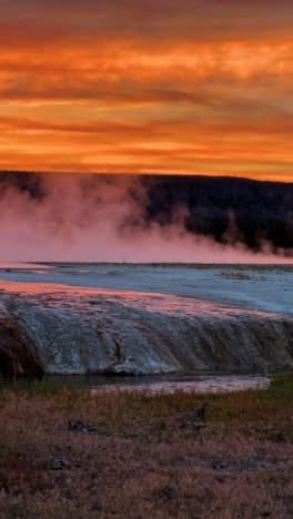 Vertikale-Ansicht-Des-Wunderschönen-Sonnenuntergangshimmels-über-Dem-Yellowstone-Nationalpark,-Dämpfe-Aus-Heißen-Quellen-Und-Geothermischem-Wasser