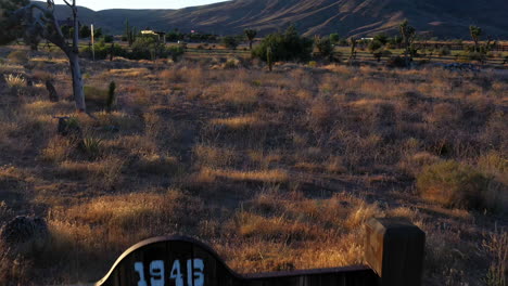 drone shot over the desert and pioneertown sign