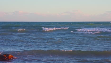 Rocky-beach,-tilting-up-into-the-horizon