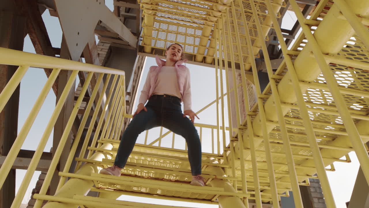 Young Woman Dancing on Stairs