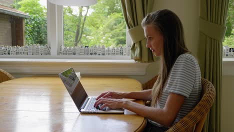 Mädchen-Sitzt-Drinnen-Am-Tisch-Und-Arbeitet-Am-Laptop,-Slider