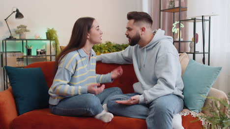aggressive family married couple man woman quarreling shouting at each other conflict at home
