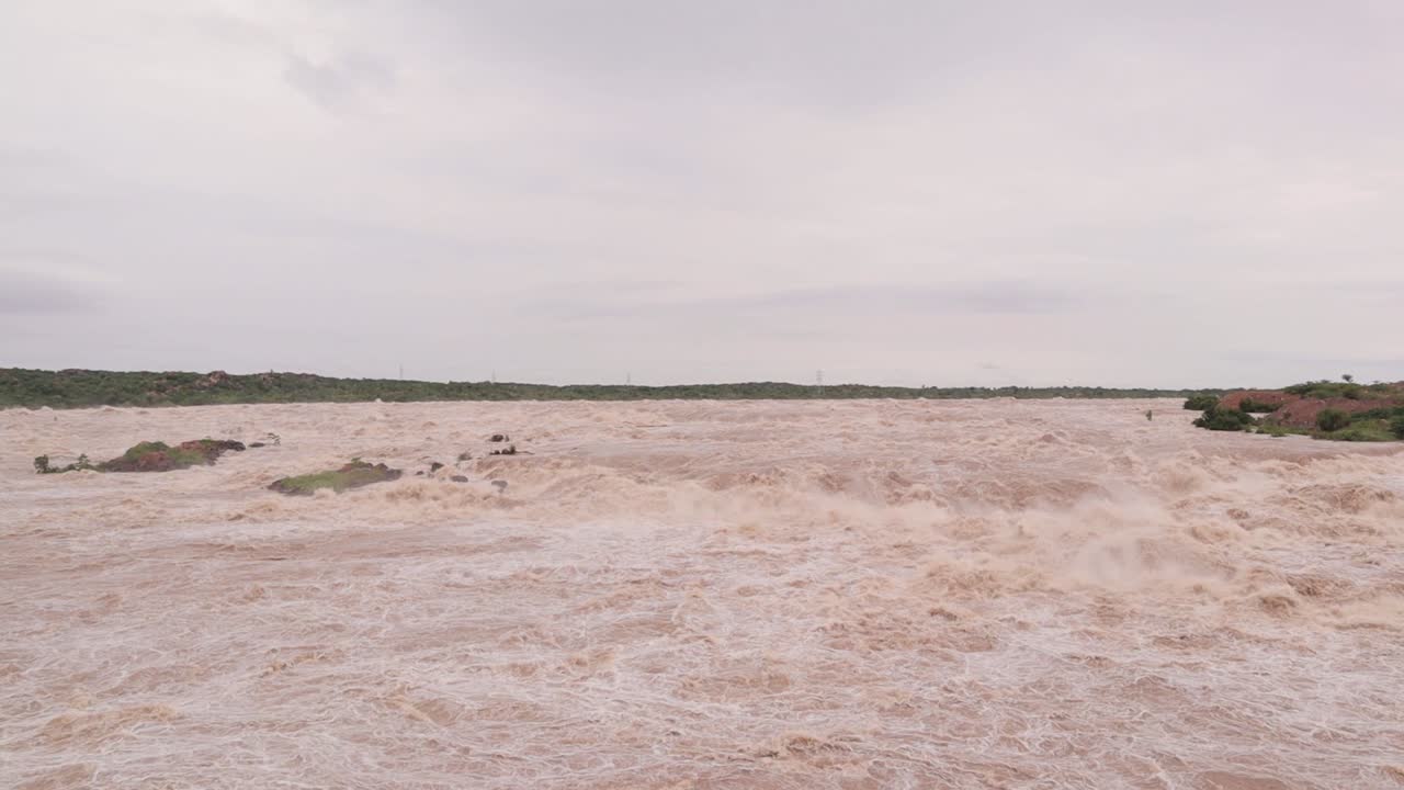 Village, trees and small hills submerged in Flood due to heavy rain causing heavy water flow from the reservoir in North Karnataka, India