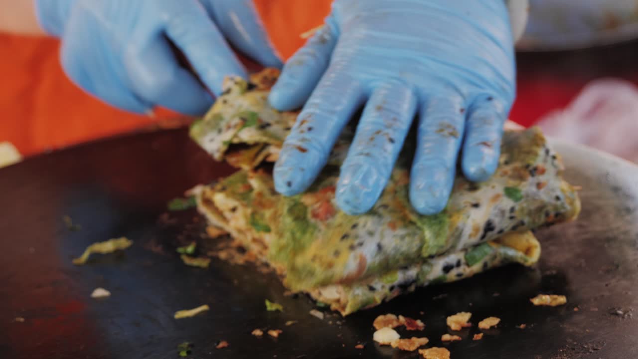 Chinese traditional street food Jianbing close-up. Cooking asian crepe Jianbing, one of China most popular street breakfasts. High quality 4k footage