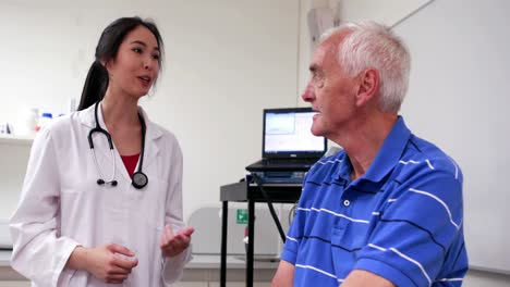 doctor talking to elderly patient