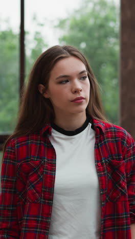 lady seeks refuge from troubled state. young woman looks at window with serene landscape providing sense of comfort and tranquility. sense of peace