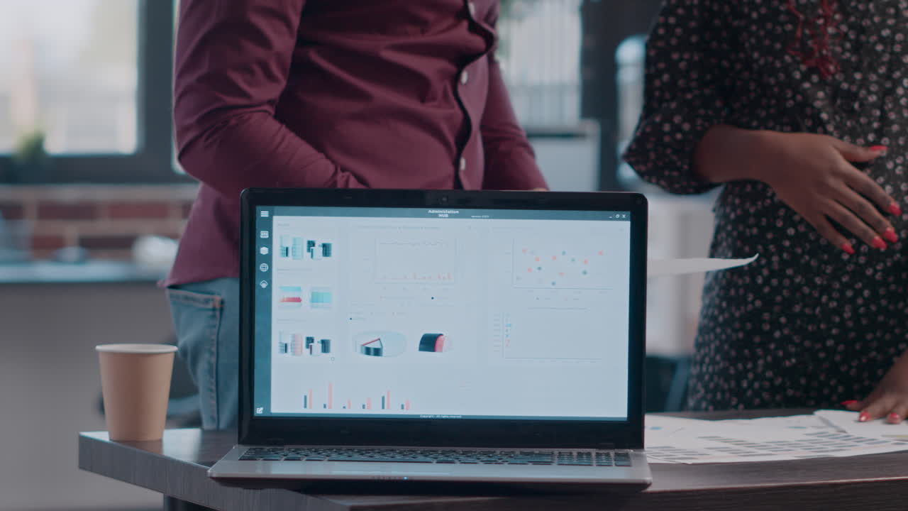 Close up of pregnant woman and man planning business project