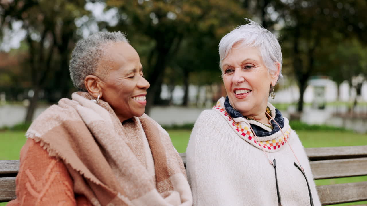 Senior women on bench in park with smile