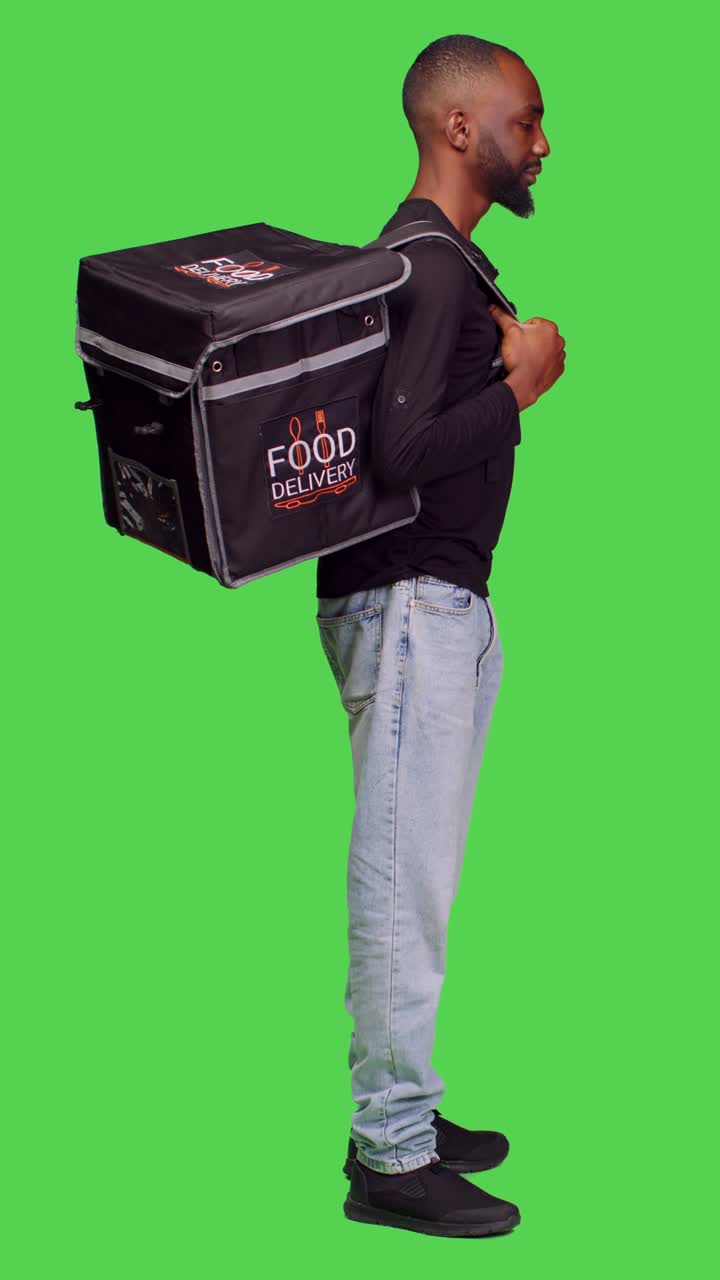 Vertical video: Profile of african american person working as deliveryman on camera