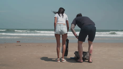 couple carrying diving equipment