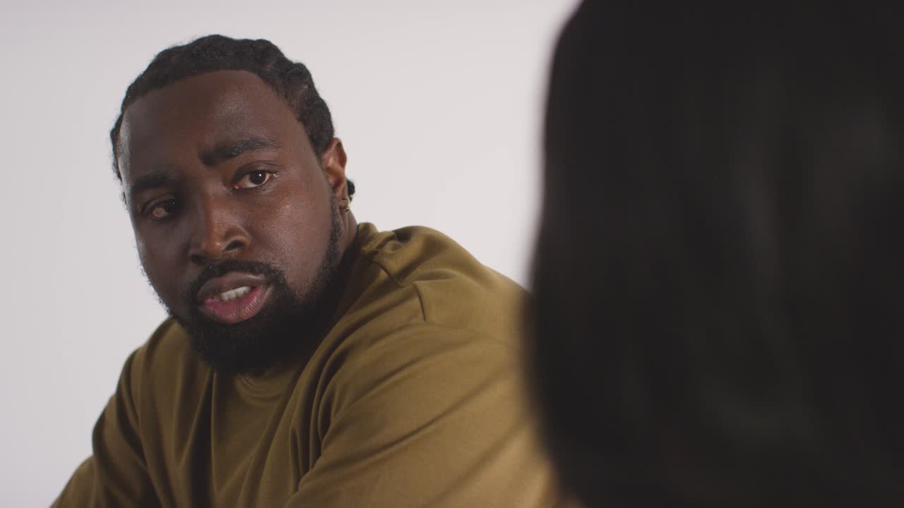 Couple At Home Sitting On Bed At Night Having Argument 9