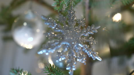 close-up focus shift between sparkling ornaments in christmas tree