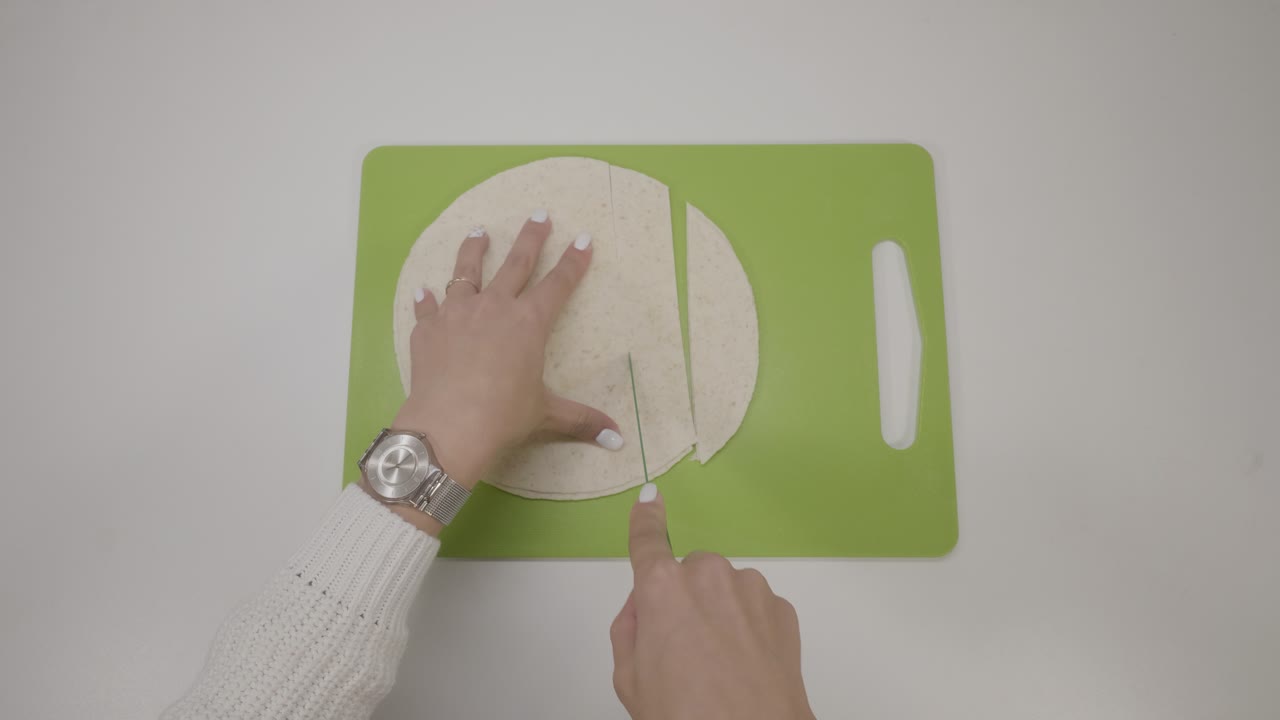 Woman cutting tortilla