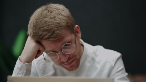 financial analyst or lawyer is reading agreement on laptop display working alone in office or home