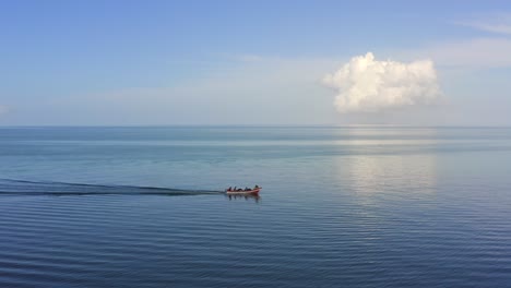 Boat-navigating-on-water-with-perfect-skyline-during-the-day-in-Coche-Island,-Venezuela