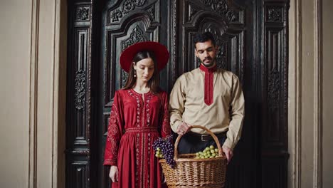 couple in traditional attire with grapes