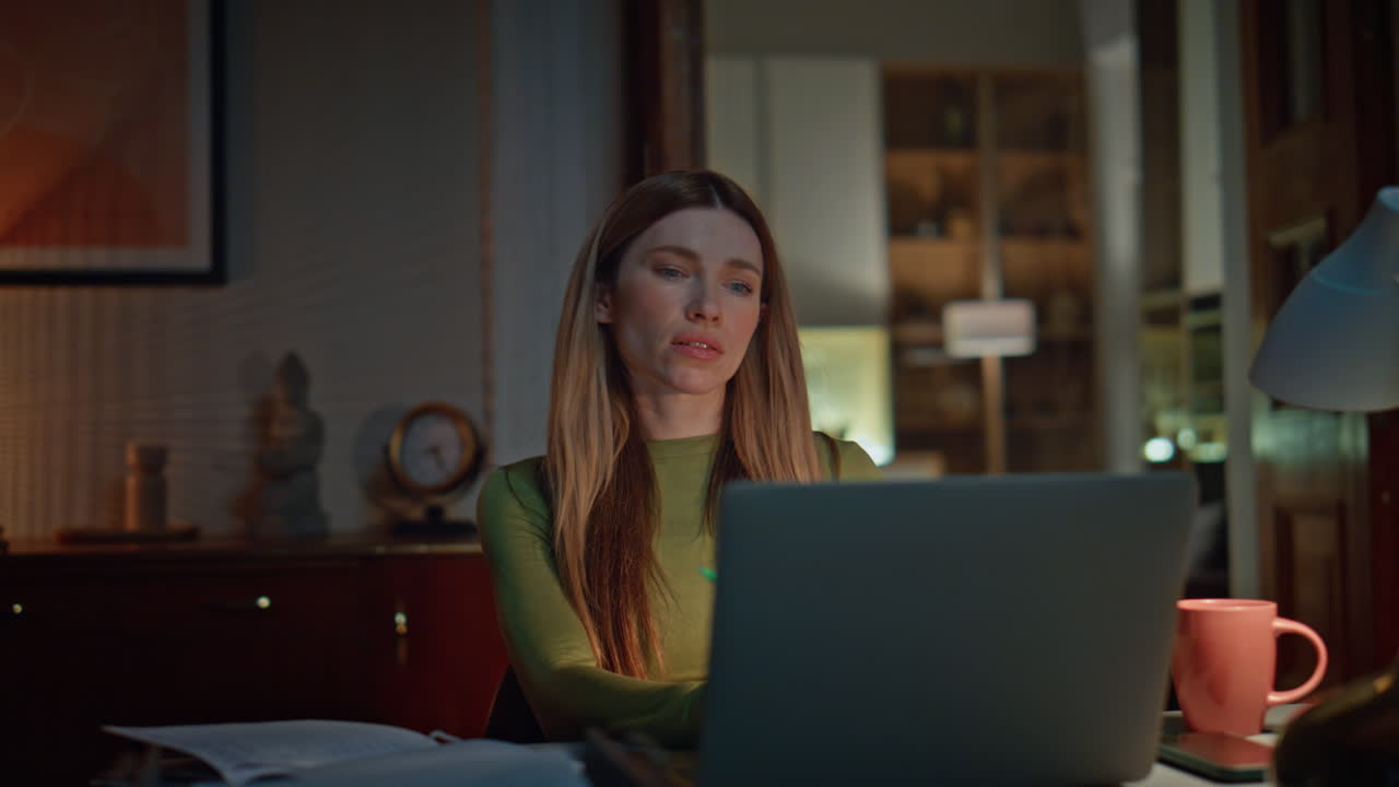 Businesswoman talking late videocall by laptop worried work problem close up.
