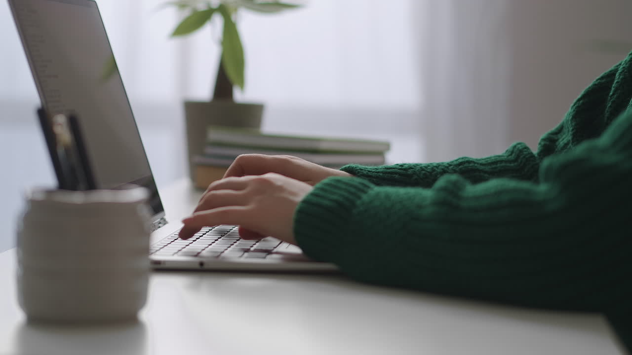 woman is typing and sending messages by laptop closeup view of female hands on keyboard in office room working day in company