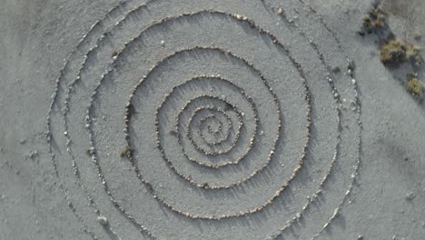 aerial top view and approximation of a spiral stone path labyrinth