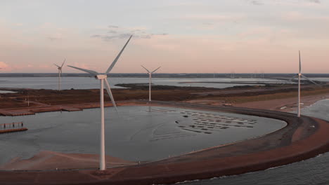 Windturbines-and-aquaculture-during-sunset-on-the-island-Neeltje-Jans,-the-Netherlands