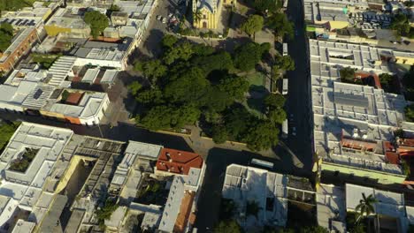 Birds-Eye-View-Beautiful-Yellow-Colonial-Cathedral-in-Urban-Neighborhood,-Merida