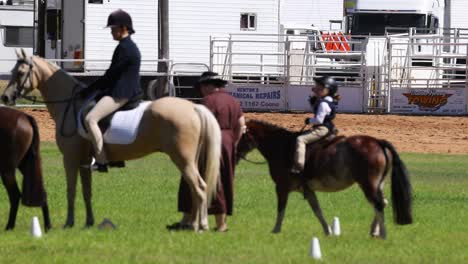 riders practicing horseback riding in an arena