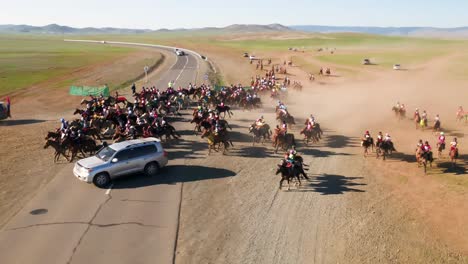 close drone shot of a group of mongolian jockeys training for a traditional naadaam