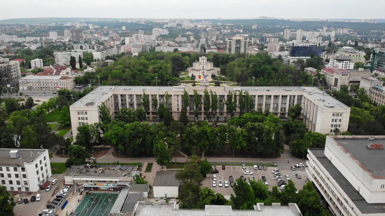 Aerial drone shot of famous buildings in center of Chisinau city. Government building, arch of triumph and cathedral in straight line. Cloudy day