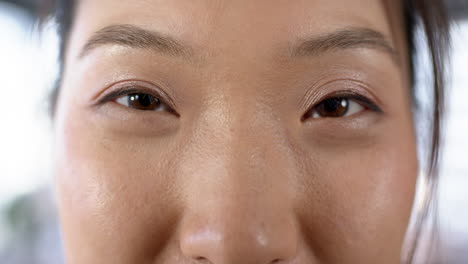 portrait of smiling asian businesswoman in office, slow motion, copy space