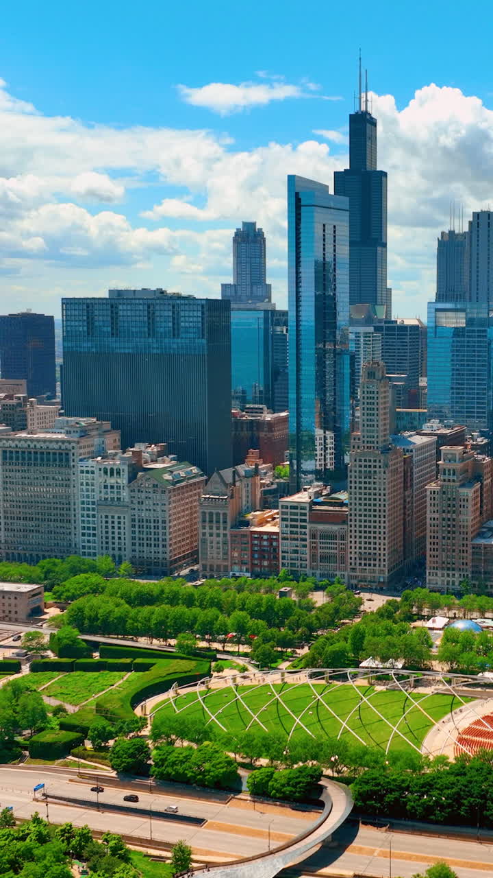 Chicago, Illinois, USA - June 01, 2024: Aerial view of the Millennium Park and Willis Tower in downtown Chicago. Vertical video