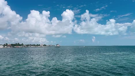 tropical coastal scenery with pier and clouds