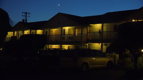 a modern economy hotel exterior establishing shot at night