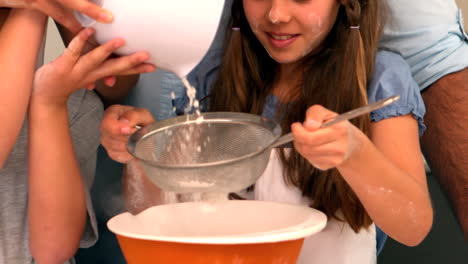 family making cake batter together