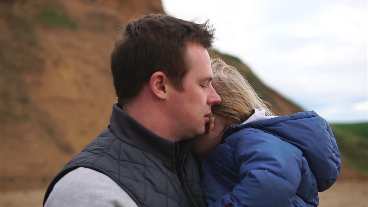 Father and Daughter Embrace at the Beach