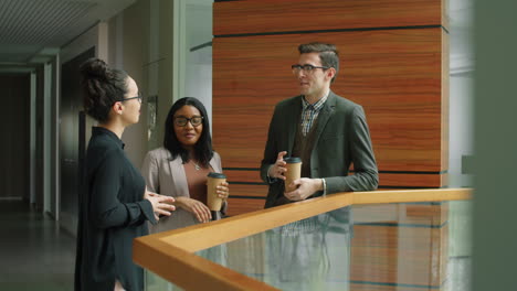 multiethnic colleagues chatting over coffee