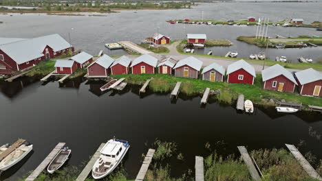 Traditional-Red-Little-Houses-Of-Fishermen-By-The-Lakeshore-In-Finland-During-Autumn-Season