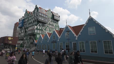 distinctive dutch architecture in zaandam with blue gabled buildings and a few tourists nearby