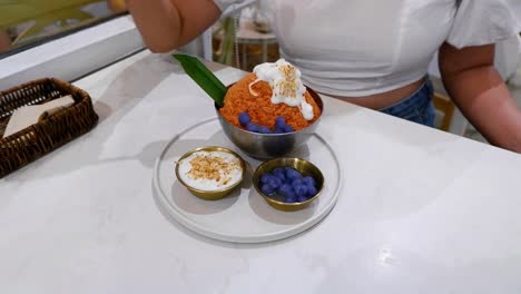 person savoring bingsu with toppings and sides