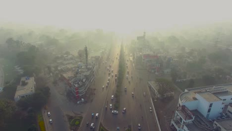 Bombay,-India,-Aerial-view-of-city-in-foggy-weather,-Focused-on-the-road,-traffic-is-going-on