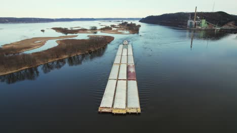 approaching lansing, iowa, a towboat pushing barges north on the mississippi river-1