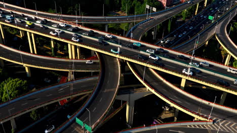 aerial top down view spectacular elevated highway and complexity, convergence of roads, bridges in modern city day time with development infrastructure with busy urban traffic