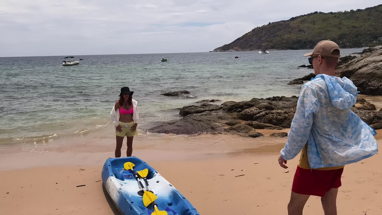 People Kayaking on a Tropical Beach