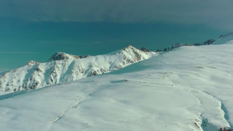 aerial: amazing view of snowcapped mountain peaks, 4k scenic winter landscape